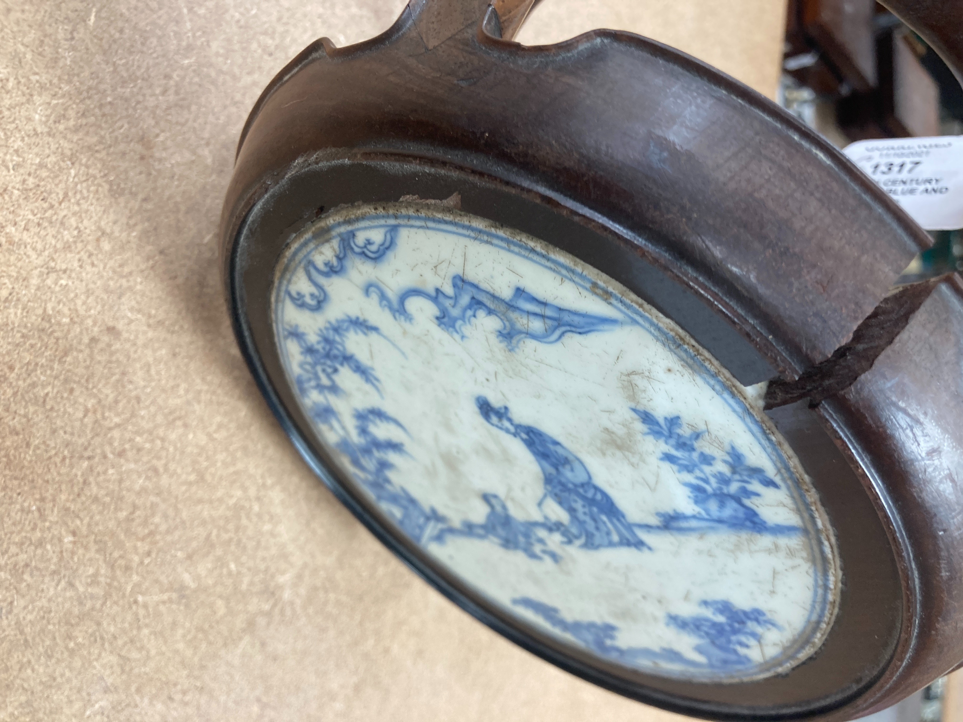 A 19th century Chinese blue and white circular tile inset hongmu stand, 22cm